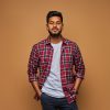 Stylish handsome indian man in tshirt on pastel background.